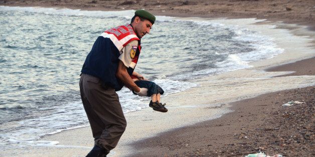 ADDS IDENTIFICATION OF CHILD A paramilitary police officer carries the lifeless body of Aylan Kurdi, 3, after a number of migrants died and a smaller number were reported missing after boats carrying them to the Greek island of Kos capsized, near the Turkish resort of Bodrum early Wednesday, Sept. 2, 2015. The family â Abdullah, his wife Rehan and their two boys, 3-year-old Aylan and 5-year-old Galip â embarked on the perilous boat journey only after their bid to move to Canada was rejected. The tides also washed up the bodies of Rehan and Galip on Turkey's Bodrum peninsula Wednesday, Abdullah survived the tragedy. (AP Photo/DHA) TURKEY OUT