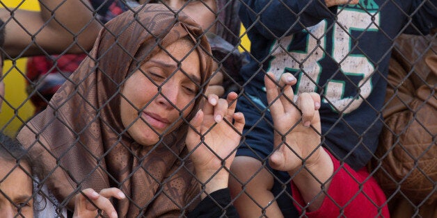 BICSKE, HUNGARY - SEPTEMBER 04: Migrants protest outside a train that they are refusing to leave for fear of being taken to a refugee camp from the train that has been held at Bicske station since yesterday on September 4, 2015 in Bicske, near Budapest, Hungary. According to the Hungarian authorities a record number of migrants from many parts of the Middle East, Africa and Asia are crossing the border from Serbia. Since the beginning of 2015 the number of migrants using the so-called Balkans route has exploded with migrants arriving in Greece from Turkey and then travelling on through Macedonia and Serbia before entering the EU via Hungary. The massive increase, said to be the largest migration of people since World War II, led Hungarian Prime Minister Victor Orban to order Hungary's army to build a steel and barbed wire security barrier along its entire border with Serbia, after more than 100,000 asylum seekers from a variety of countries and war zones entered the country so far this year. (Photo by Matt Cardy/Getty Images)