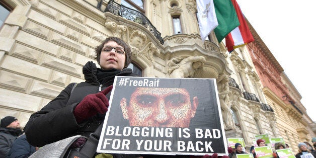 FILE - In this Friday, Feb. 6, 2015 file photo, members of the Austrian Greens protest against the punishment for Saudi blogger Raif Badawi in front of the KAICIID in Vienna, Austria. Saudi Arabia's Supreme Court upheld a verdict against a liberal blogger who was flogged in January after being found guilty of insulting Islam and breaking technology laws, state-linked news websites reported Sunday, June 7. (AP Photo/Hans Punz, File)