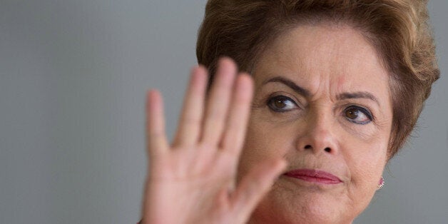 FILE - In this July 17, 2015 file photo, Brazil's President Dilma Rousseff waves to the press as she arrives to greet leaders arriving for a Mercosur Summit at Itamaraty Palace in Brasilia, Brazil. Dep. Eduardo Cunha, the speaker of Brazilâs lower house of Congress is Rousseffâs sworn enemy who has been charged with taking millions in bribes in connection to a sprawling corruption scandal at state-run oil company Petrobras. Heâs also the man who can call for an impeachment vote in the House of Deputies against the president, an action that two-thirds of Brazilians polled say they want to see happen. (AP Photo/Joedson Alves, File)