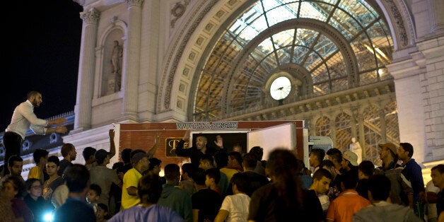 People organize food distribution at Keleti train station in Budapest, Serbia, Friday, Sept. 4, 2015. In a bid to ease the cr