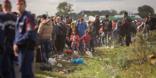 BUDAPEST, HUNGARY - SEPTEMBER 07: Migrants who have just crossed into Hungary wait for buses to take them to a reception camp on September 7, 2015 in Roszke, Hungary. As the migrant crisis in Europe continues, an estimated 18000 people arrived in Germany over the weekend with thousands more following in their wake along the Balkan route. (Photo by Matt Cardy/Getty Images)