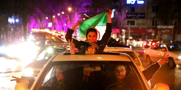 Iranians celebrate on a street in northern Tehran, Iran, Thursday, April 2, 2015, after Iran's nuclear agreement with world p