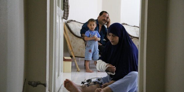 HATAY, TURKEY - MAY 31: Syrian refugees Muhammed Fevaz Sireki and his sister Rana demand support for a prosthetic leg to return to the old days on May 31, 2015 in Turkey's Hatay. When Assad regime forces hit the house of Sireki siblings with barrel bombs, they became permanently disabled. Now, Muhammed Fevaz Sireki and his sister Rana fled their home due to the civil war hold on life in refugee camp in Hatay province of southern Turkey. (Photo by Cem Genco/Anadolu Agency/Getty Images)