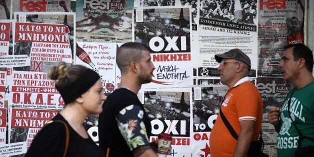 Pedestrians pass posters of left-wing parties in the northern Greek city of Thessaloniki, Tuesday, Sept. 15, 2015. Alexis Tsipras the leader of left-wing party leader Syriza and former Prime Minister Alexis Tsipras called a snap election for Sunday, Sept. 20 after reaching an agreement with eurozone countries for a third bailout, and has clung to a slim lead in opinion polls despite a sharp drop in his approval ratings. (AP Photo/Giannis Papanikos)