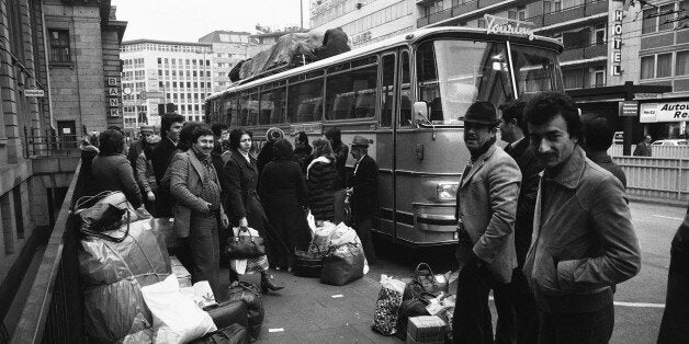 Turkish guest workers wait with luggage for the weekly bus to Istanbul from Frankfurt, Germany around Dec. 2, 1978. (AP Photo/Rolf Boehm)