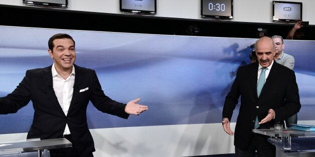 Former Greek Prime Minister and leader of the left-wing Syriza party Alexis Tsipras (L) jokes with main opposition conservati