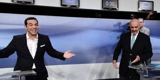 Former Greek Prime Minister and leader of the left-wing Syriza party Alexis Tsipras (L) jokes with main opposition conservative New Democracy leader, Vangelis Meimarakis before a live pre-election televised debate at the state-run ERT television in Athens, on September 14, 2015. Greece's snap election next weekend will be a cliffhanger, with latest opinion polls on September 13 giving the radical left Syriza party only a razor-thin lead over its conservative rivals. AFP PHOTO/ LOUISA GOULIAMAKI (Photo credit should read LOUISA GOULIAMAKI/AFP/Getty Images)