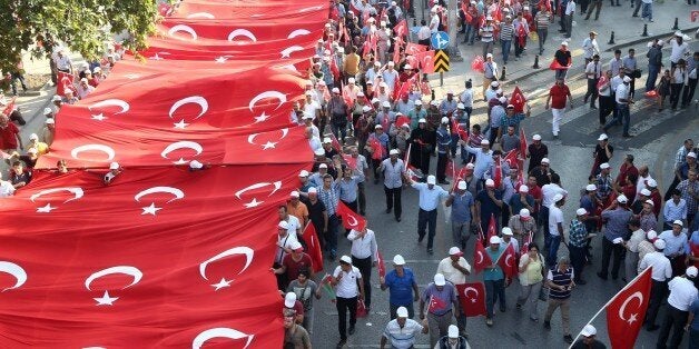 People wave the Turkish national flag as they demonstrate to condemn terrorism and attacks against Turkish security forces, in Ankara, on September 17, 2015. More than 10,000 people took part in the anti-terrorism rally in Turkey's capital Ankara on Thursday, as the army continues a major offensive against Kurdish militants, who have killed dozens of security force members since July. The non-partisan rally was organised by a coalition of NGOs, trade unions and business groups, under the slogan 'Yes to unity and solidarity, no to terror'. AFP PHOTO / ADEM ALTAN (Photo credit should read ADEM ALTAN/AFP/Getty Images)