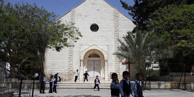 A picture taken on May 3, 2014 shows Catholic and Muslim children playing in the yard of the Catholic school of Gaza City. C