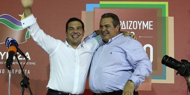 ATHENS, GREECE - SEPTEMBER 20: Alexis Tsipras and ANEL Leader Panos Kammenos (R) speak to crowd in Athens, Greece, on September 20, 2015. With nearly two-thirds of votes counted, Alexis Tsipras Syriza party seems highly likely to have won Greeces early general election. (Photo by Ayhan Mehmet/Anadolu Agency/Getty Images)