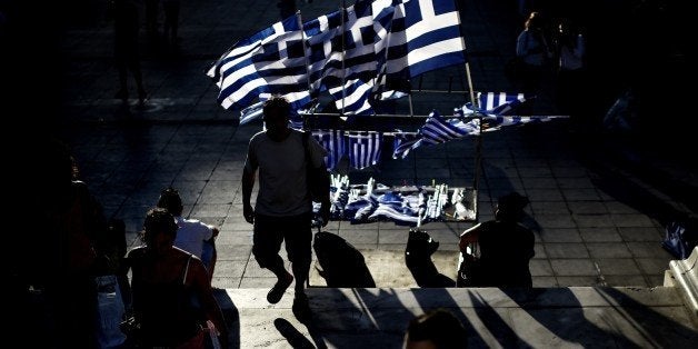 Greek flags stand for sale before the main pre-election rally of the Radical Left party SYRIZA in central Athens Syntagma square on September 18, 2015. Final polls before Sunday's key Greek election gave a slim lead to radical left former prime minister Alexis Tsipras over his conservative rival. AFP PHOTO / ARIS MESSINIS (Photo credit should read ARIS MESSINIS/AFP/Getty Images)