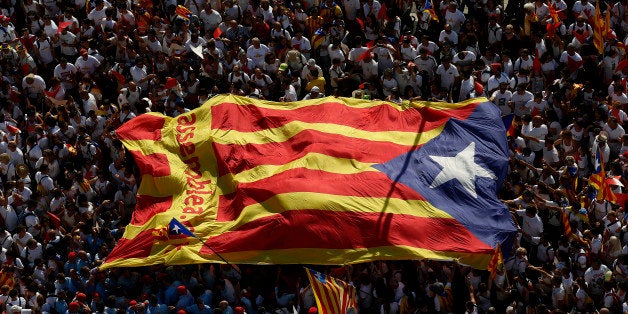 People carry a giant âesteladaâ flag, a symbol of Catalonian pro-independence, during a demonstration calling for the ind