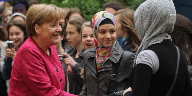 BERLIN, GERMANY - MAY 16: German Chancellor Angela Merkel greets students at the Sophie Scholl school during a visit on the fifth European Union school project day on May 16, 2011 in Berlin, Germany. The nationwide initiative is meant to foster a stronger understanding young people of the role of the European Union. (Photo by Sean Gallup/Getty Images)