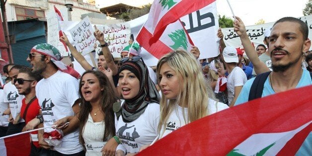 Lebanese protesters wave national flags during a demonstration denouncing Lebanon's stagnant political system, that has become the target of demonstrations following a trash crisis, on September 20, 2015, in the capital Beirut. AFP PHOTO / ANWAR AMRO (Photo credit should read ANWAR AMRO/AFP/Getty Images)