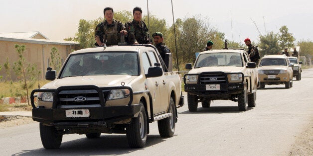 Afghan National Army soldiers arrive to start an operation soon, outside of Kunduz city, north of Kabul, Afghanistan, Wednesday, Sept. 30. The U.S. military says it has conducted two more airstrikes overnight on Taliban positions around a northern Afghan city seized by the insurgents this week. (Najim Rahim via AP)