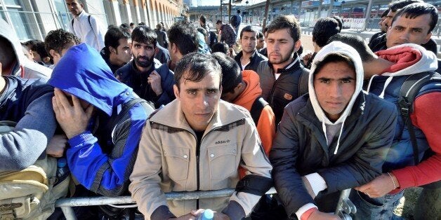 PASSAU, GERMANY - SEPTEMBER 30: Refugees, come from mainly from Afghanistan, Syria and Iraq, arrive at the railway station September 30, 2015 in Passau, Germany. They have been waiting for the further transport on busses which will take them to different reception camps. (Photo by Falk Heller/Anadolu Agency/Getty Images)