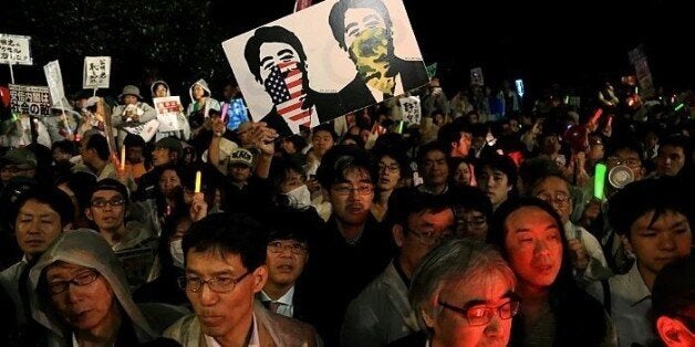 TOKYO, JAPAN - SEPTEMBER 17: People protest against the new Japan Security Bill on September 17, 2015 in Tokyo, Japan. Hundreds of people gathered to protest against the security bills to expand the roles of Japan Self Defense Force. The scheduled committee vote, which is the second to last vote before the law officially being passed, has been repeatedly delayed by the opposition party. The ruling coalition party lawmakers are aiming to pass the legislation before the end of week. (Photo by MASASHI KATO/Getty Images)