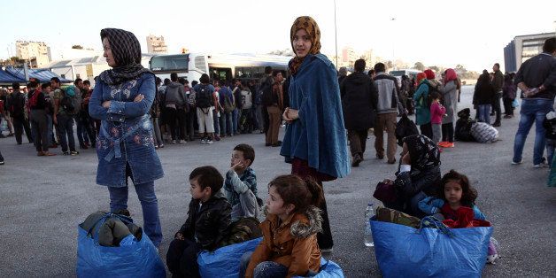 Migrants and refugees wait to get on buses which will transfer them at a metro station after their arrival from the Greek island of Lesbos at the Athens' port of Piraeus, Sunday, Oct. 4, 2015. The U.N. refugee agency is reporting a ânoticeable dropâ this week in arrivals of refugees by sea into Greece - as the total figure for the year nears the 400,000 mark. Overall, the UNHCR estimates 396,500 people have entered Greece via the Mediterranean this year with seventy percent of them are from war-torn Syria. (AP Photo/Yorgos Karahalis)