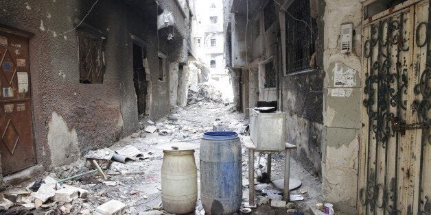 Rubble and heavy damage remain on a deserted street during a government escorted visit to Yarmouk refugee camp in Damascus, S