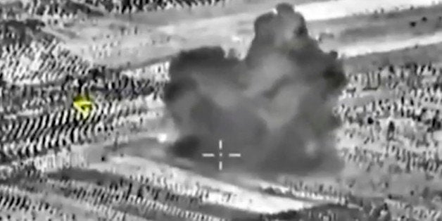 This image made from footage taken from Russian Defense Ministry official website on Friday, Oct. 2, 2015, shows another attack made from a fighter jet in Syria. The Russian Defense Ministry says its aircraft have carried out 18 sorties in Syria in the past 24 hours, including 10 overnight in which seven sites were bombed. The annotations on the image were made by the source and indicate the center of the target, and its direction, yellow. (AP Photo/ Russian Defense Ministry Press Service)