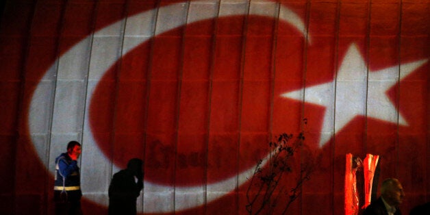 ** TURKEY OUT ** People walk near the site of an explosion earlier in the day in Ankara, Turkey, late Saturday, Oct. 10, 2015. Two bomb explosions targeted a peace rally Saturday by leftist and Kurdish activists in the Turkish capital, killing 95 people and wounding 246, the government said.The attack was Turkey's deadliest in recent years. (AP Photo/Emrah Gurel) TURKEY OUT