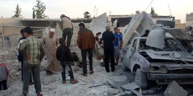 ALEPPO, SYRIA - OCTOBER 13 : Syrian people search for the air attack victims after Russian war crafts hit the Syrian opposit