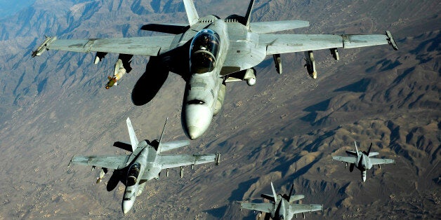 November 25, 2010 - Four U.S. Navy F/A-18 Hornet aircraft fly over mountains in Afghanistan.