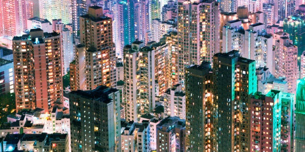 China, Hong Kong, apartment blocks, at night, elevated view.