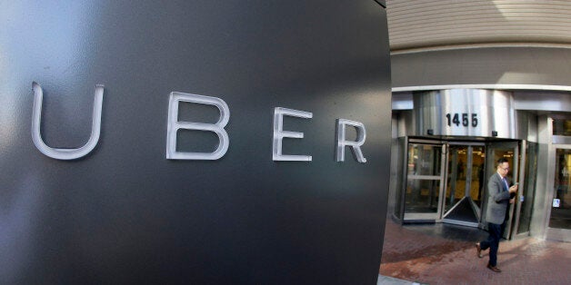 FILE - In this Dec. 16, 2014, file photo a man leaves the headquarters of Uber in San Francisco. Uber, Lyft and other ride-hailing companies may soon be able to pick up passengers at Los Angeles International Airport after debate over whether their drivers are properly screened to weed out criminals. (AP Photo/Eric Risberg, File)