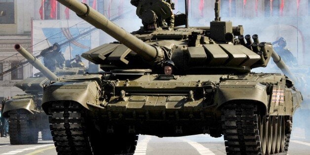 Russian tanks parade on Dvortsovaya (Palace) Square in St.Petersburg during the Victory Day ceremony at on May 9, 2015. Russian President Vladimir Putin on May 9 presided over a huge military parade to commemorate the 70th anniversary of victory over Nazi Germany, brushing off a snub by Western leaders over Ukraine. In what is seen as punishment for Kremlin meddling in Ukraine, Western countries led by Russia's World War II allies boycotted the May 9 festivities, leaving Putin to mark the day in the company of the leaders of China, Cuba and other Moscow-friendly figures. AFP PHOTO / OLGA MALTSEVA (Photo credit should read OLGA MALTSEVA/AFP/Getty Images)