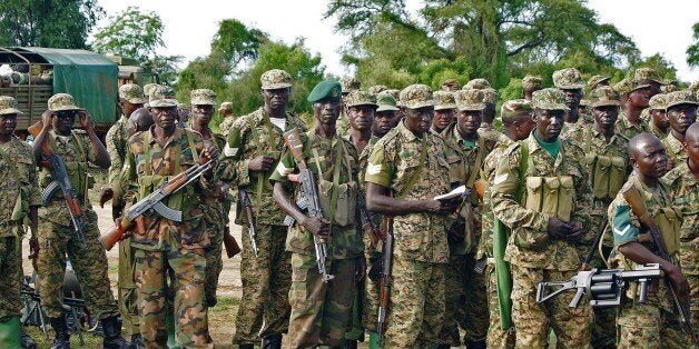 Uganda People's Defence Force (UPDF) troops assemble amongst their vehicles in Bor on October 20, 2015. The South Sudanese mi