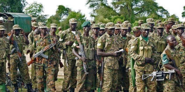 Uganda People's Defence Force (UPDF) troops assemble amongst their vehicles in Bor on October 20, 2015. The South Sudanese military leadership has announced that of the thousands of the UPDF troops, those stationed in Bor, Jonglei states capital, will be the first to be transported back to Uganda in line with a peace deal aimed at ending nearly two years of civil war on October 23, 2015. AFP PHOTO/Samir Bol (Photo credit should read SAMIR BOL/AFP/Getty Images)