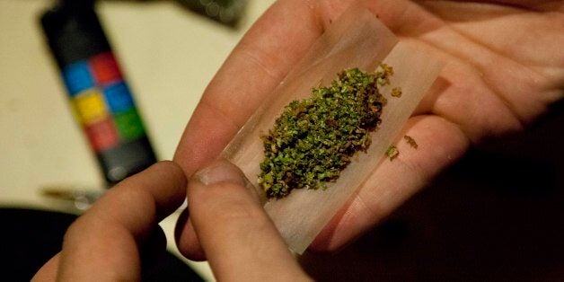 In this Aug. 13, 2013 photo, a man rolls marijuana that was grown in a hydroponic garden inside an apartment in Mexico City. Mexico growers say their home-cultivation phenomenon is removed from the grisly narco-wars that have wracked the country. In fact, growing and swapping among themselves, they contend, allows them to avoid supporting the cartels. (AP Photo/Eduardo Verdugo)