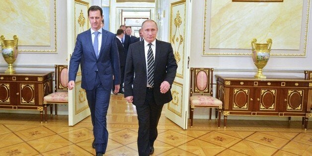 Russian President Vladimir Putin (R) greets his Syrian counterpart Bashar al-Assad upon his arrival for a meeting at the Kremlin in Moscow on October 20, 2015. Assad, on his first foreign visit since Syria's war broke out, told his main backer and counterpart Putin in Moscow that Russia's campaign in Syria has helped contain 'terrorism'. AFP PHOTO / RIA NOVOSTI / KREMLIN POOL / ALEXEY DRUZHININ (Photo credit should read ALEXEY DRUZHININ/AFP/Getty Images)