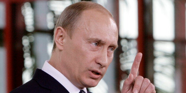 Russia's president Vladmir Putin gesturesduring a joint news conference with Italy's Premier-elect Silvio Berlusconi (not vis