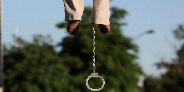 Feet of convicted man Mahdi Faraji, is seen with shackle, while he is being hanged, at the city of Qazvin about 80 miles (130 kilometers) west of the capital Tehran, Iran, Thursday, May, 26, 2011. Iran's official news agency is reporting that five prisoners have been hanged in public, including a convicted serial killer. The others had been found guilty of rape and armed robbery. Thursday's hangings brought the number of executions to 130 since the beginning of the year. The figure was compiled from local media reports. The report by the IRNA news agency identifies one of the executed prisoners as Mahdi Faraji and says he was convicted of killing five woman and stealing their jewelry. (AP Photo/Mehr News Agency, Hamideh Shafieeha)