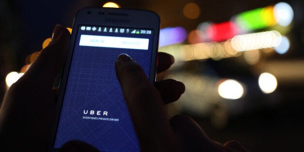 BERLIN, GERMANY - SEPTEMBER 02: In this photo illustration, a woman uses the Uber app on an Samsung smartphone on September 2, 2014 in Berlin, Germany. Uber, an app that allows passenger to buy rides from drivers who do not have taxi permits, has had its UberPop freelance driver service banned in Germany after a complaint by Taxi Deutschland, a trade association of taxi drivers in the country. The company, which operates in 42 countries over 200 cities worldwide, plans to both appeal the decision made by a court in Frankfurt as well as, at the risk of heavy fines, continue its services in Germany until a final decision has been made on the matter. (Photo by Adam Berry/Getty Images)