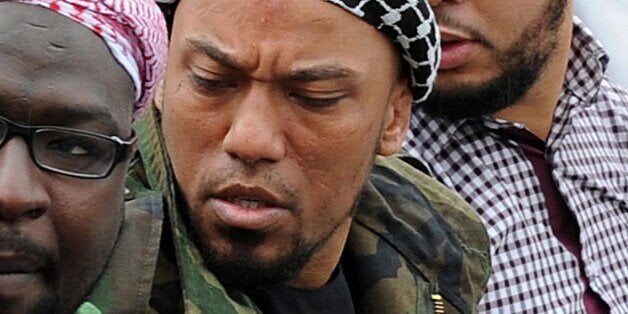 Picture taken on May 5, 2012 shows former German rapper Denis Cuspert (C) among salafi in Bonn, Germany. Denis Mamadou Cusper