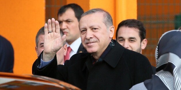 ISTANBUL, TURKEY - NOVEMBER 1: President of Turkey Recep Tayyip Erdogan greets people after casting his ballot in the Turkey's 26th general election at a polling station in Istanbul, Turkey on November 01, 2015. More than 54 million Turkish voters head to the polls on Sunday in a rerun of Juneï¿½ï¿½s inconclusive election. (Photo by Metin Pala/Anadolu Agency/Getty Images)