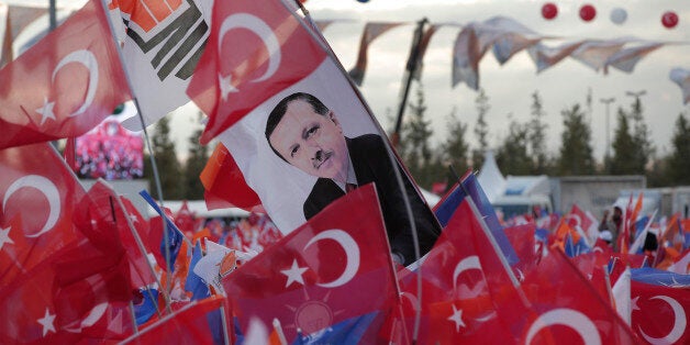 Supporters of Turkish Prime Minister Ahmet Davutoglu and leader of the Justice and Development Party (AKP), wave Turkish flags, party s posters and a banner with former party leader and current Turkish President Recep Tayyip Erdogan, as they wait for Davutoglu to deliver a speech at a rally in Istanbul, Sunday, Oct. 25, 2015, ahead of the Nov. 1 general elections. (AP Photo/Lefteris Pitarakis)