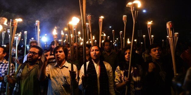 Bangladeshi activists take part in a torch-lit protest in Dhaka on November 2, 2015 against the killing of secular publisher Faisal Arefin Dipan. Bangladesh bookshop owners on November 2 kept the shutters of their shops closed protesting the murder of a secular publisher at his own office in a Dhaka market on October 31. AFP PHOTO / Munir uz ZAMAN (Photo credit should read MUNIR UZ ZAMAN/AFP/Getty Images)