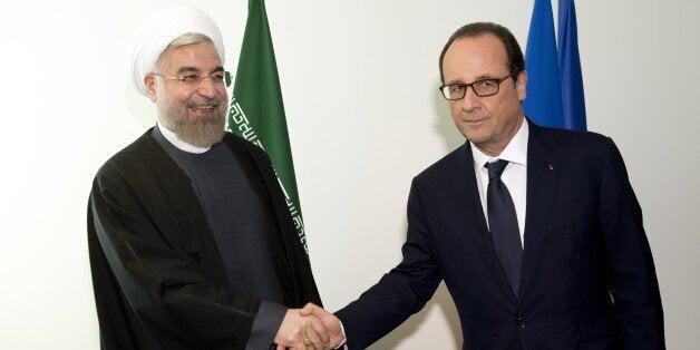 French President Francois Hollande (R) shakes hands with Iranian President Hassan Rouhani on the sidelines of the 69th United