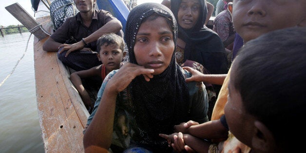 Rescued migrants weep upon arrival Simpang Tiga, Aceh province, Indonesia, Wednesday, May 20, 2015. Hundreds of migrants stranded at sea for months were rescued and taken to Indonesia, officials said Wednesday, the latest in a stream of Rohingya and Bangladeshi migrants to reach shore in a growing crisis confronting Southeast Asia. (AP Photo/Binsar Bakkara)