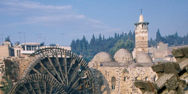 Syria, Central, Hama, Wooden norias or waterwheels on the Orontes river and the Al-Nuri Mosque dating from 1172 and built of