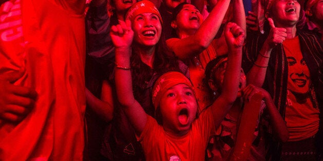 YANGON, MYANMAR - NOVEMBER 09: A child stands with crowds gathered for the election result announcement in front of the National League for Democracy's headquarters after Myanmar's first free and fair election on November 9, 2015 in Yangon, Myanmar. The elections are Myanmar's first openly contested polls in 25 years, following decades of military rule. Noble laureate Aung San Suu Kyi appeared poised to win power in Myanmar on today despite her party's growing concerns about cheating in yesterday's historic election. (Photo by Lauren DeCicca/Getty Images)