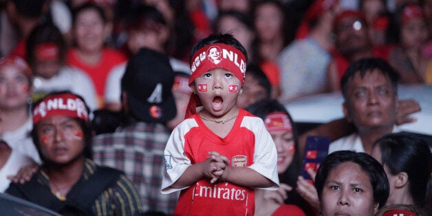 YANGON, Nov. 10, 2015-- A child watches the vote counting of the multi-party general election in front of the opposition Nati