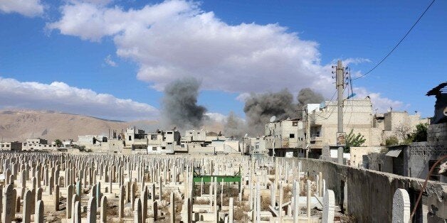 DAMASCUS, SYRIA - NOVEMBER 10: Smoke rises after Assad regime forces' strike, staged to residential areas, in Douma District of East Ghouta region of Damascus, Syria on November 10, 2015. (Photo by Muhammed Khair/Anadolu Agency/Getty Images)