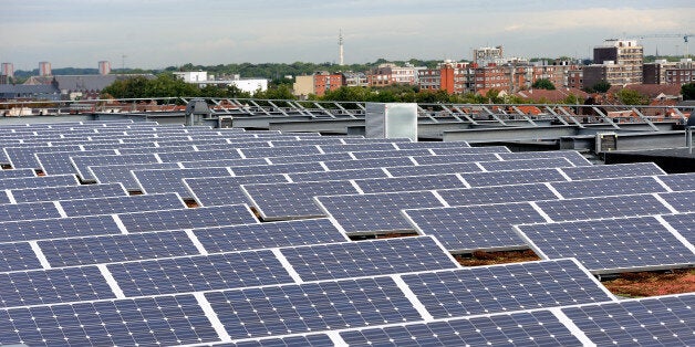 A picture shows solar panels installed on the roof of a building in Lille on September 9, 2013. AFP PHOTO/PHILIPPE HUGUEN