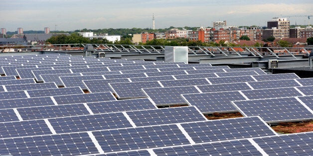 A picture shows solar panels installed on the roof of a building in Lille on September 9, 2013. AFP PHOTO/PHILIPPE HUGUEN (Photo credit should read PHILIPPE HUGUEN/AFP/Getty Images)